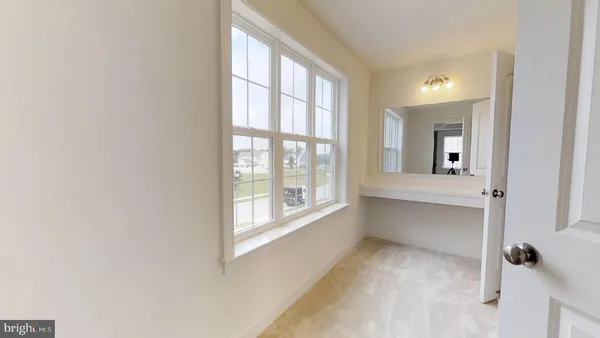 a view of a room with a white wall