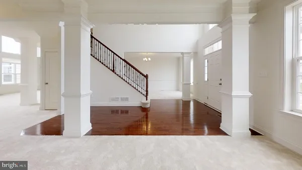 a view of entryway and hall with wooden floor