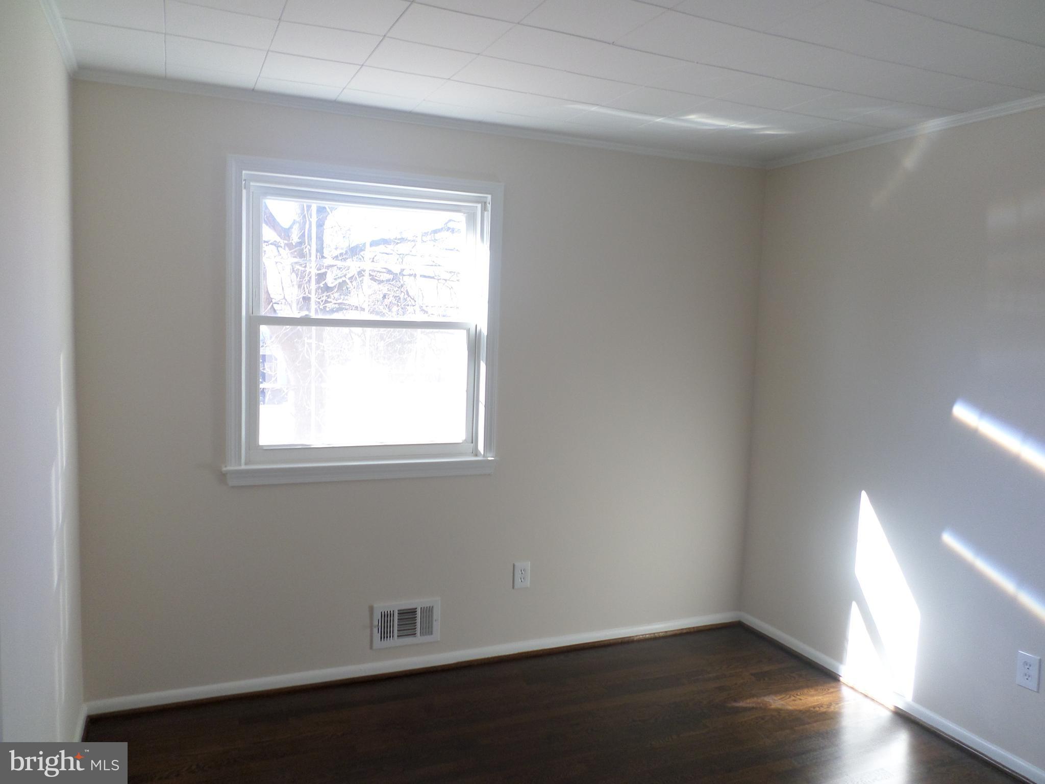 2976 Gracefield Road Silver Spring, MD 20904 - Photo 13 of 25 an empty room with wooden floor and windows