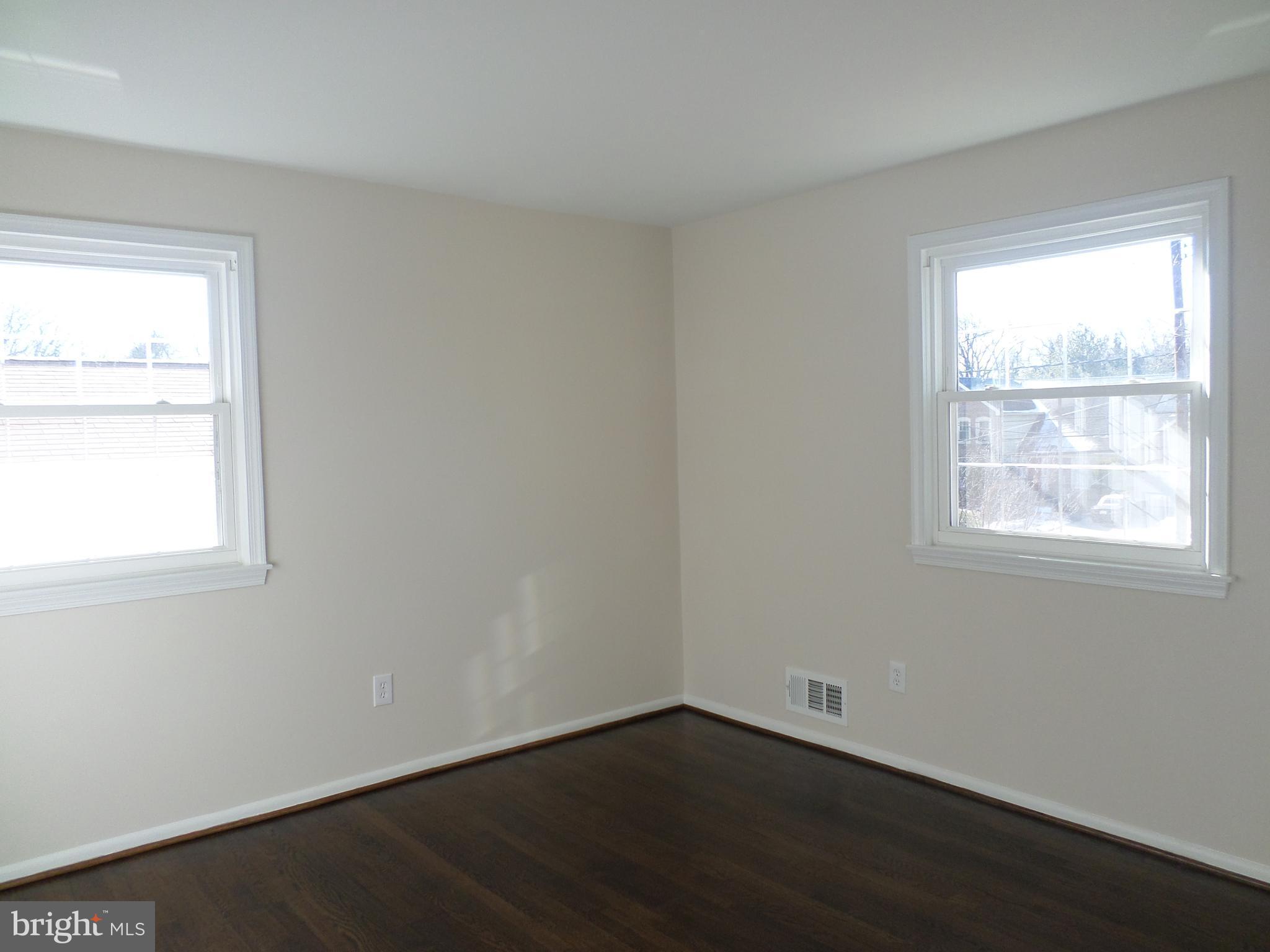 2976 Gracefield Road Silver Spring, MD 20904 - Photo 14 of 25 an empty room with wooden floor and windows