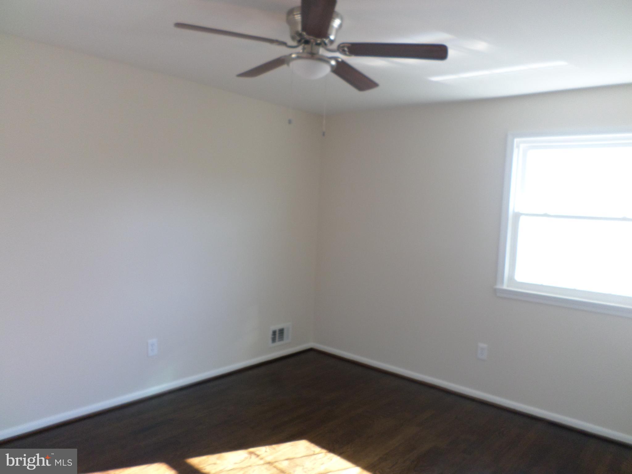 2976 Gracefield Road Silver Spring, MD 20904 - Photo 15 of 25 an empty room with a window and fan