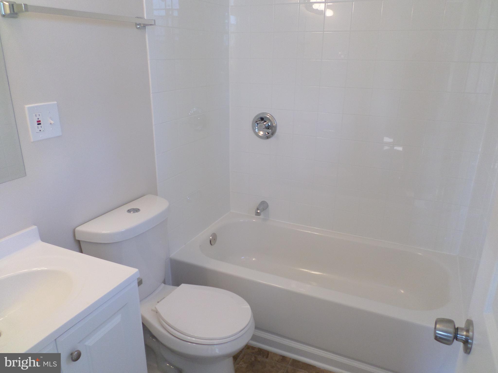 2976 Gracefield Road Silver Spring, MD 20904 - Photo 16 of 25 a white toilet sitting next to a bath tub