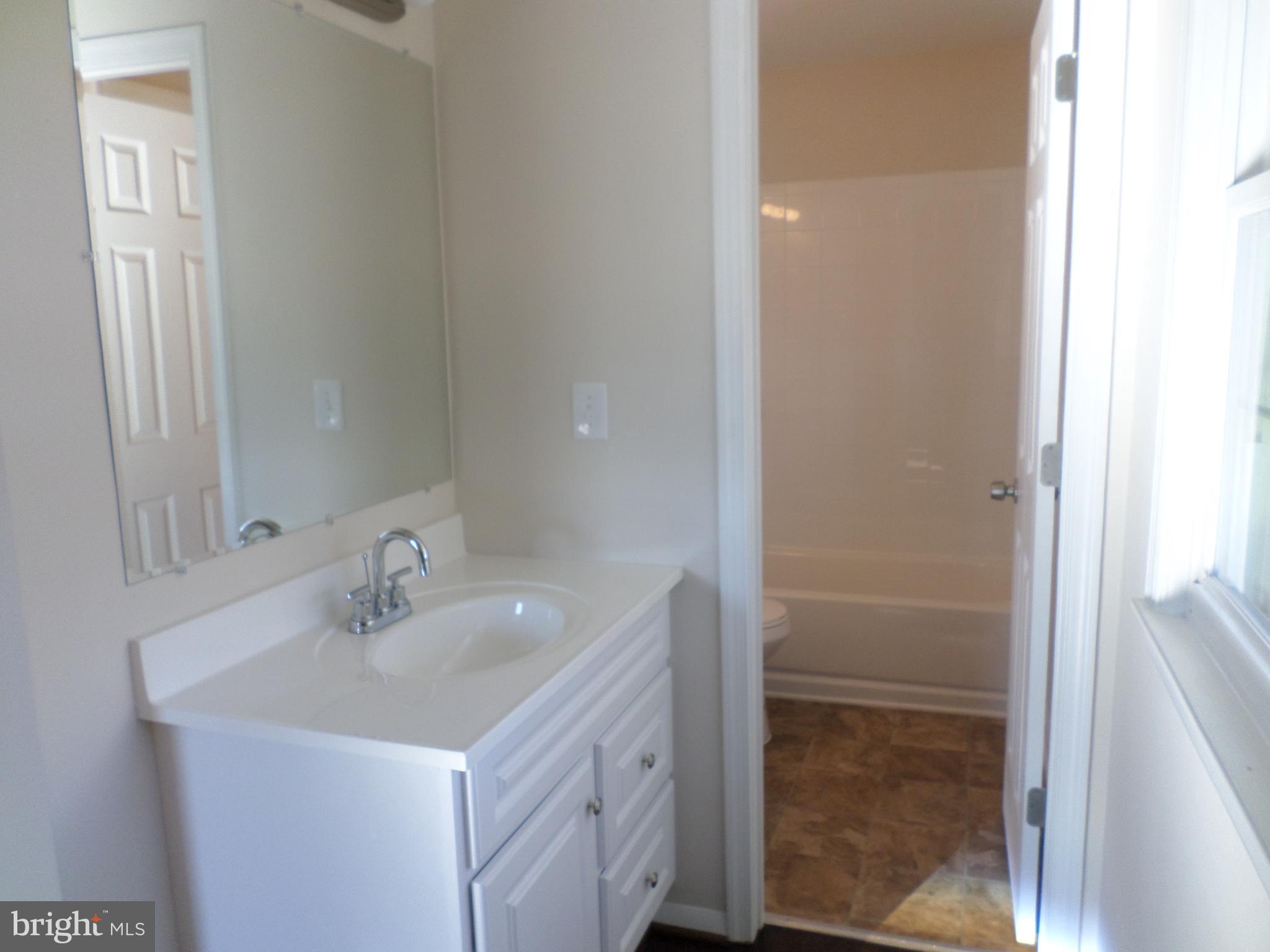 2976 Gracefield Road Silver Spring, MD 20904 - Photo 17 of 25 a bathroom with a sink and a mirror