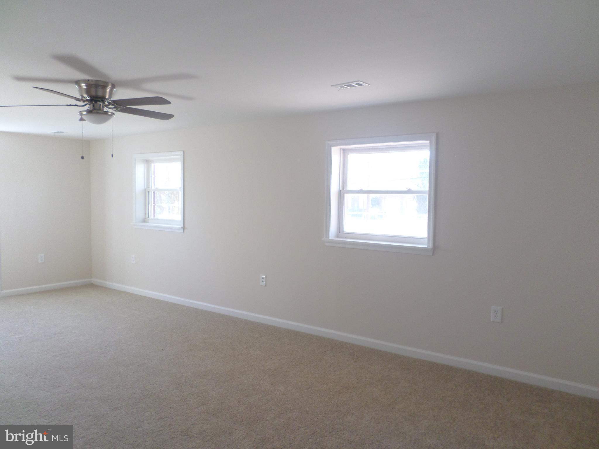 2976 Gracefield Road Silver Spring, MD 20904 - Photo 18 of 25 an empty room with a window and ceiling fan