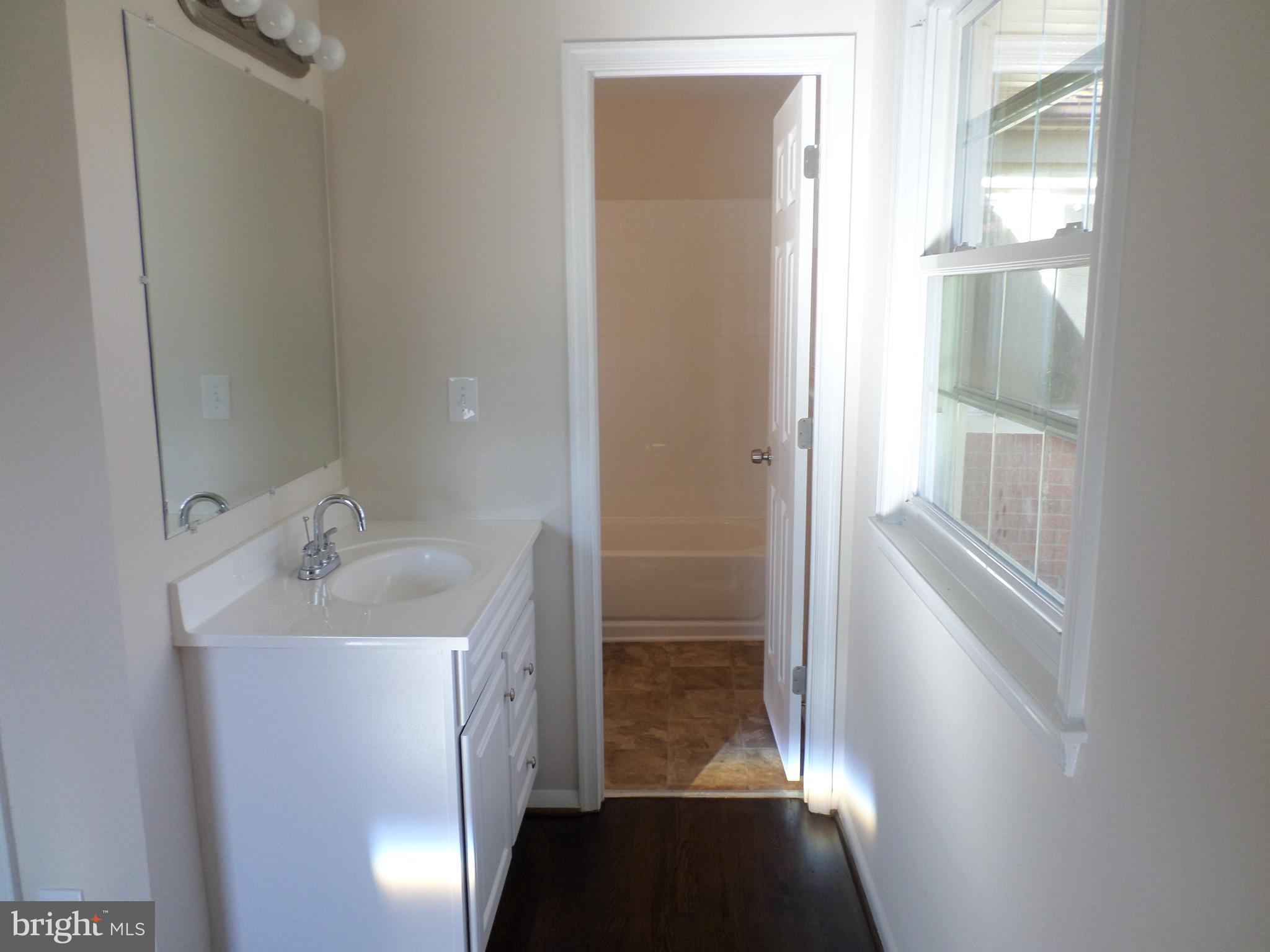 2976 Gracefield Road Silver Spring, MD 20904 - Photo 20 of 25 a bathroom with a sink and a mirror