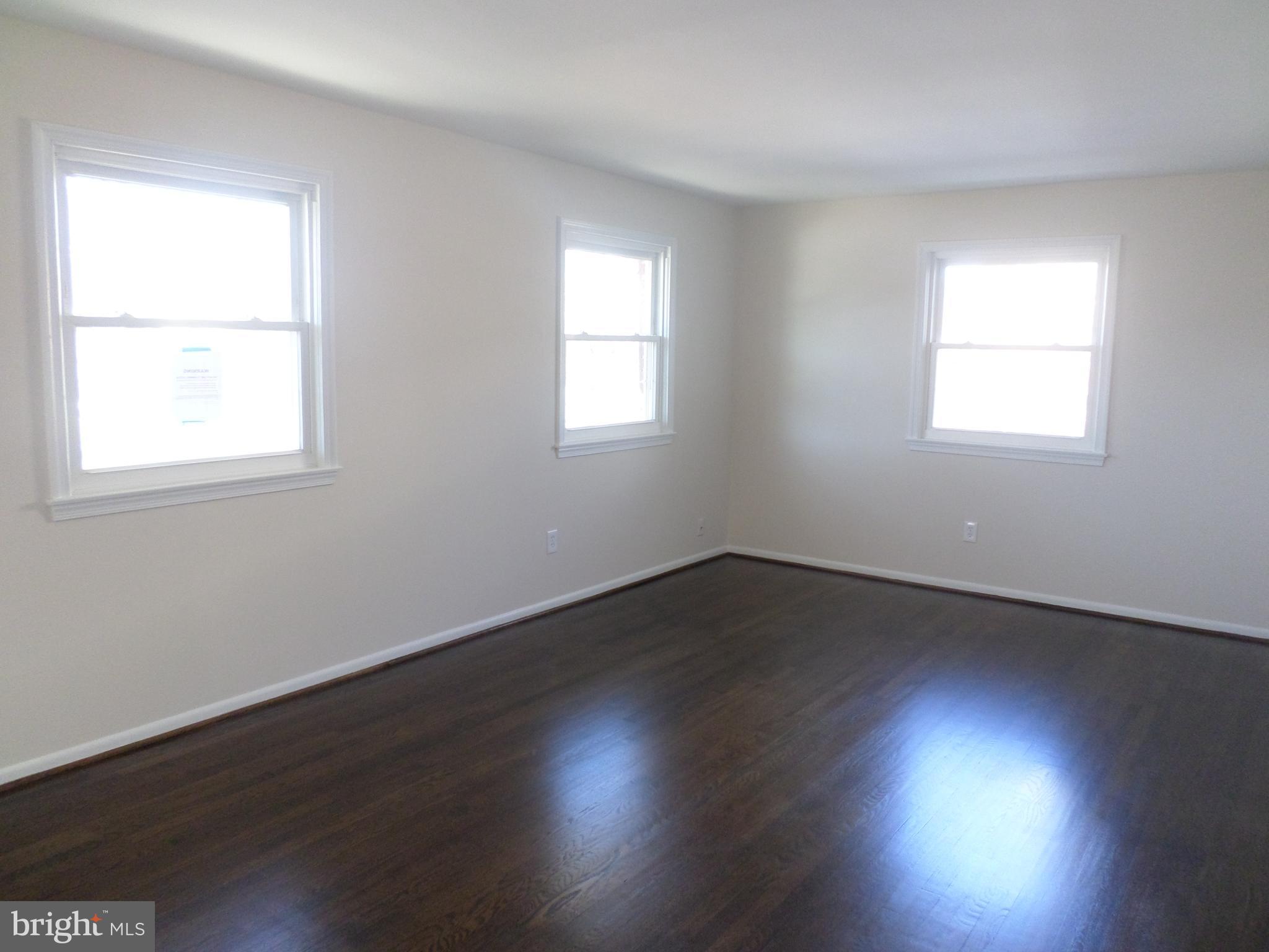 2976 Gracefield Road Silver Spring, MD 20904 - Photo 3 of 25 an empty room with wooden floor and windows