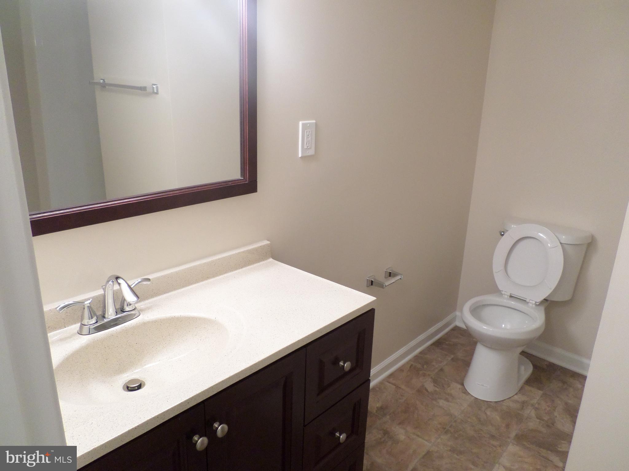 2976 Gracefield Road Silver Spring, MD 20904 - Photo 24 of 25 a bathroom with a sink toilet and vanity