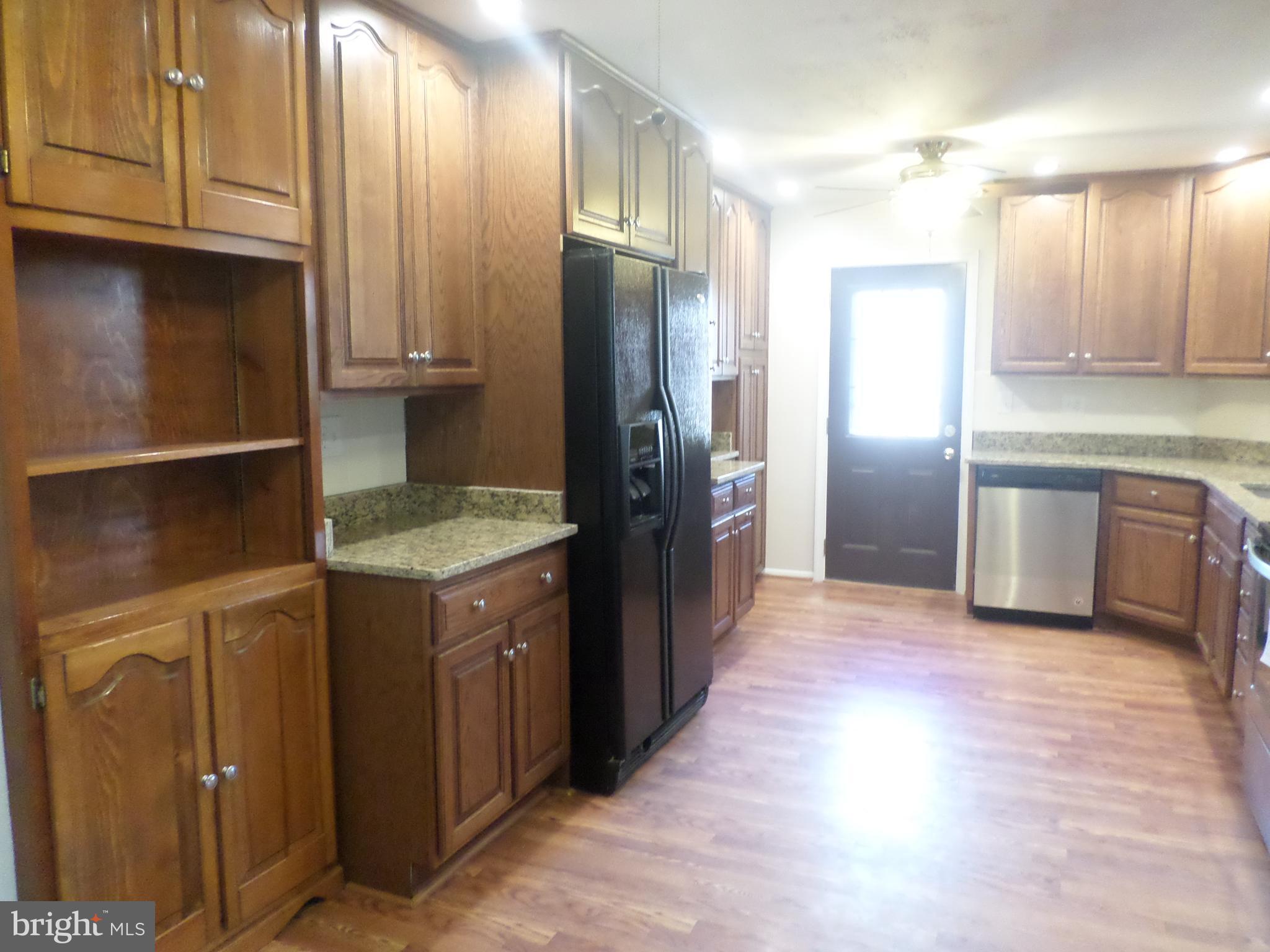 2976 Gracefield Road Silver Spring, MD 20904 - Photo 8 of 25 a kitchen with stainless steel appliances granite countertop a refrigerator and a sink