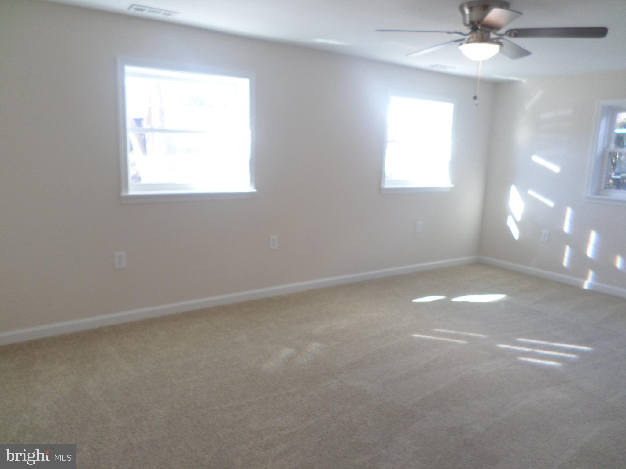 2976 Gracefield Road Silver Spring, MD 20904 - Photo 9 of 25 an empty room with a window and a fan