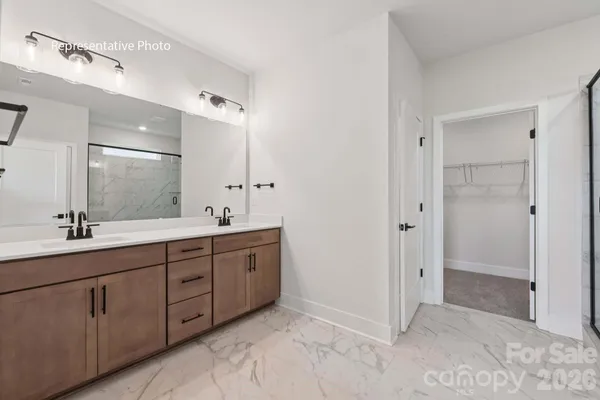 a spacious bathroom with a double vanity sink mirror and double