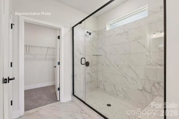 a bathroom with a glass shower door