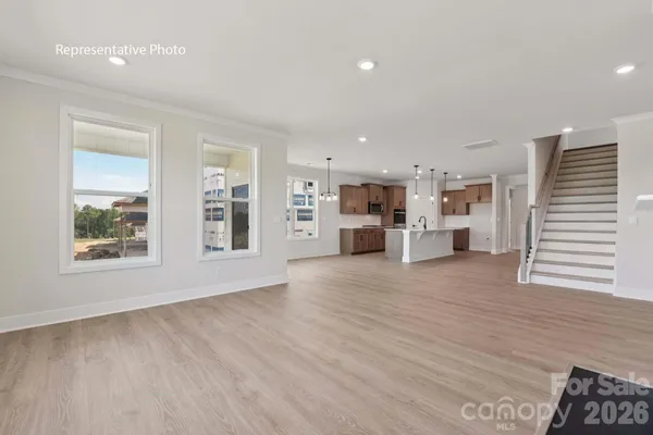a view of kitchen with stainless steel appliances refrigerator oven and stove with wooden floor
