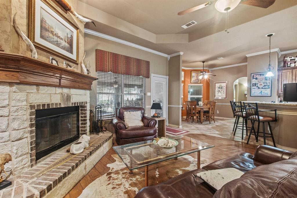 112 Knight Court Springtown, TX 76082 - Photo 6 of 26 Stone-front fireplace with a wood mantel