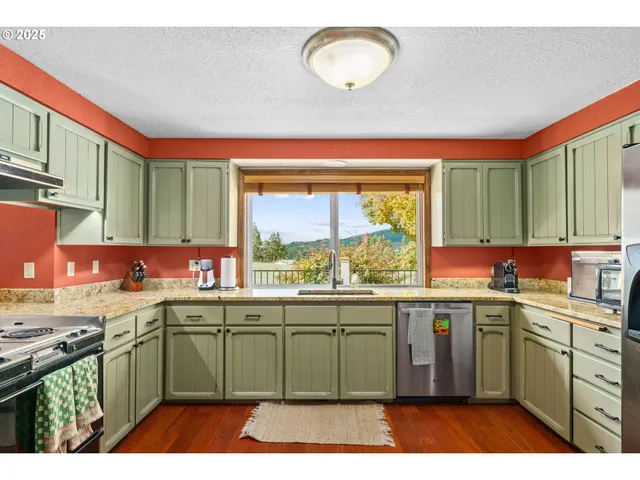 a kitchen with a sink and large window
