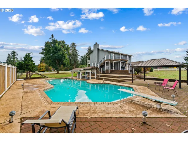 a view of a swimming pool with an outdoor space and seating area