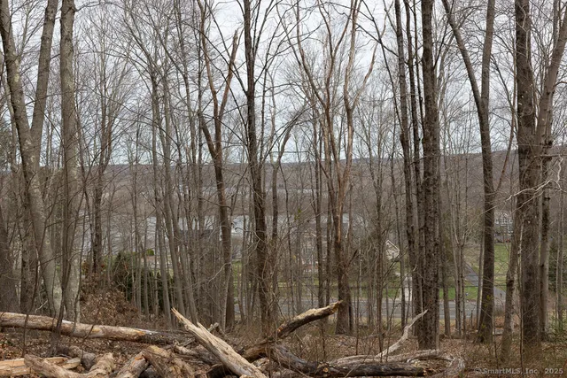 a wooden fence with trees in the background