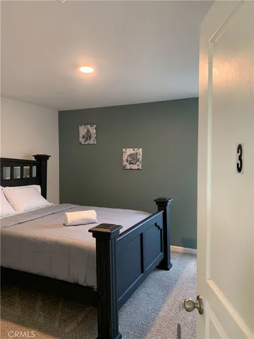 a bedroom with a bed and a table