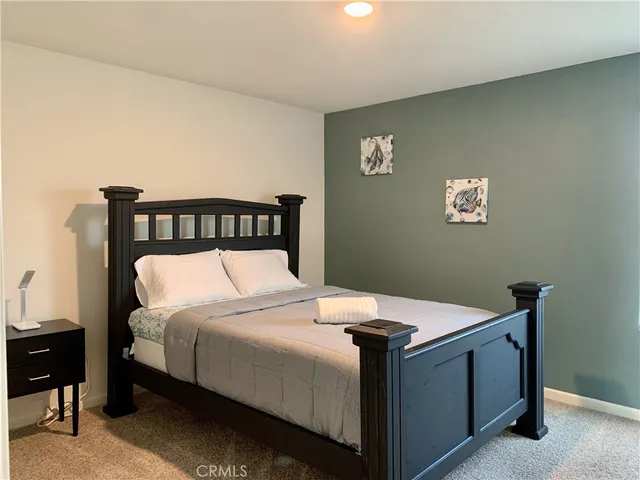 a bedroom with a bed and a table in it