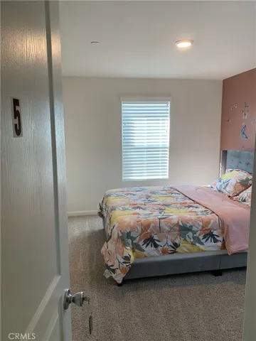 a bedroom with a bed and a mirror