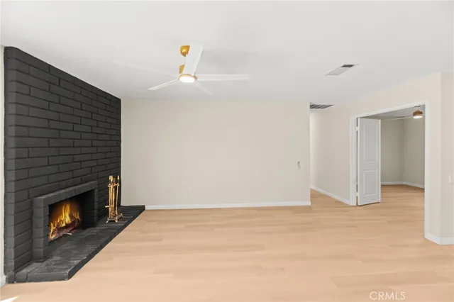 a view of an empty room and fire place
