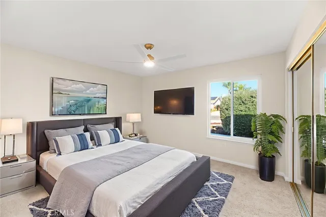 a bedroom with a large bed and a chandelier