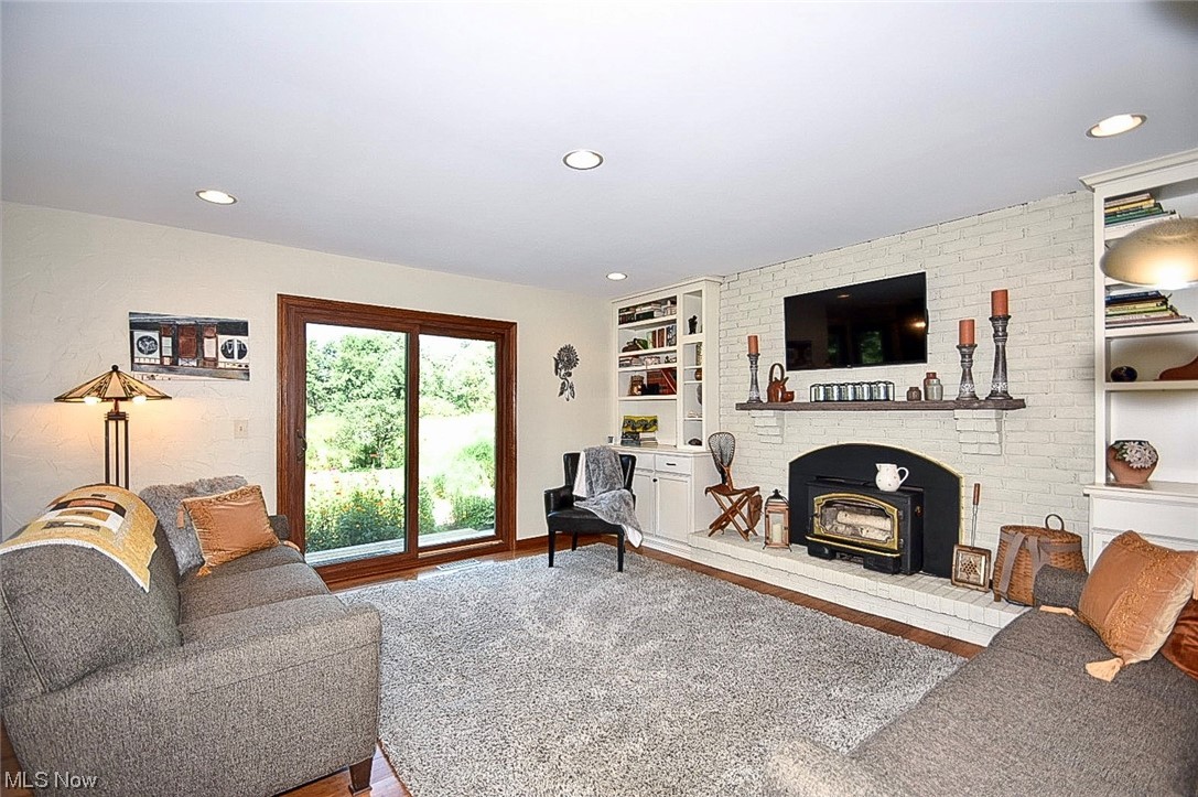 781 Yager Road Clinton, OH 44216 - Photo 22 of 34 Hardwood floored living room with built in features and a fireplace