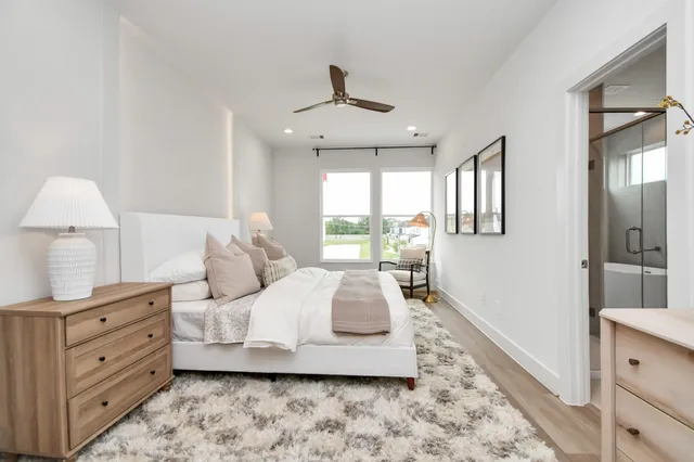 a bedroom with a large bed and a dresser