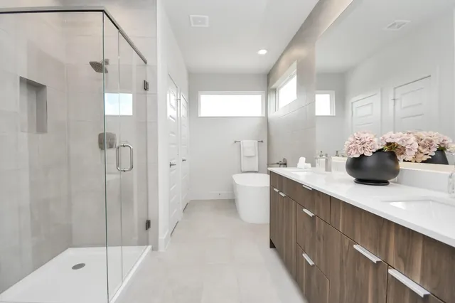 a bathroom with a sink a toilet and shower