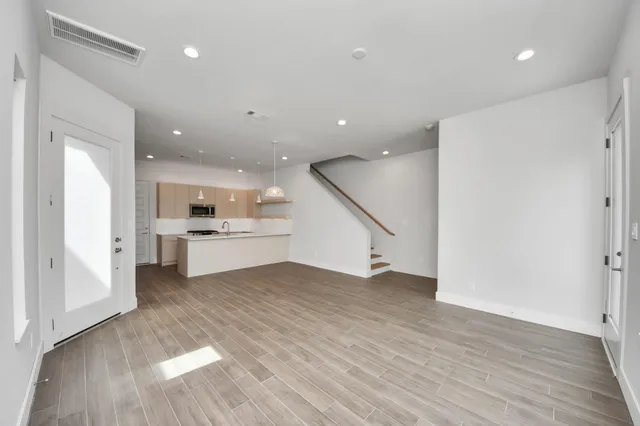 a view of kitchen with cabinets and wooden floor