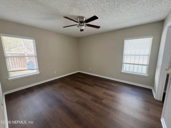 a view of wooden floor and windows in a room