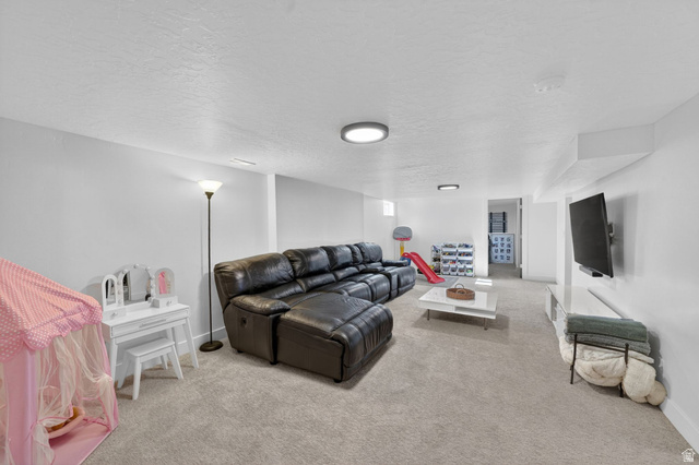 66 South 425 West Bountiful, UT 84010 - Photo 17 of 25 Spacious lower-level entertainment area featuring recessed lighting, light-toned carpeting, and a wall-mounted television