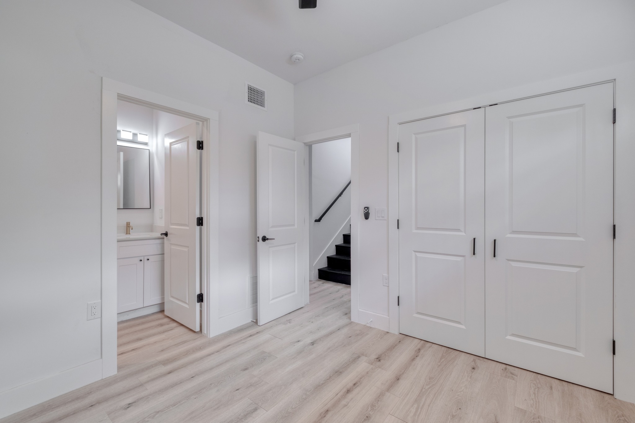 5211 Rob-Scott Street Austin, TX 78721 - Photo 19 of 24 Clean lines and light-toned flooring create an inviting atmosphere in this versatile space.