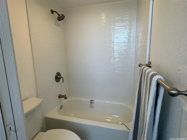 a kitchen with granite countertop a refrigerator and a sink
