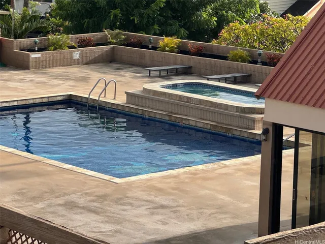 a swimming pool with lawn chairs