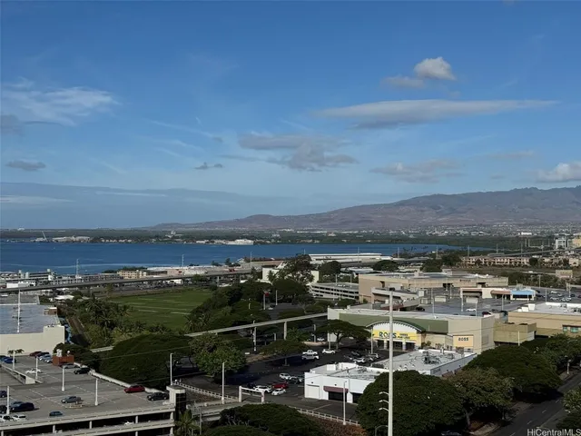 a bathroom with a granite countertop sink a mirror and a shower
