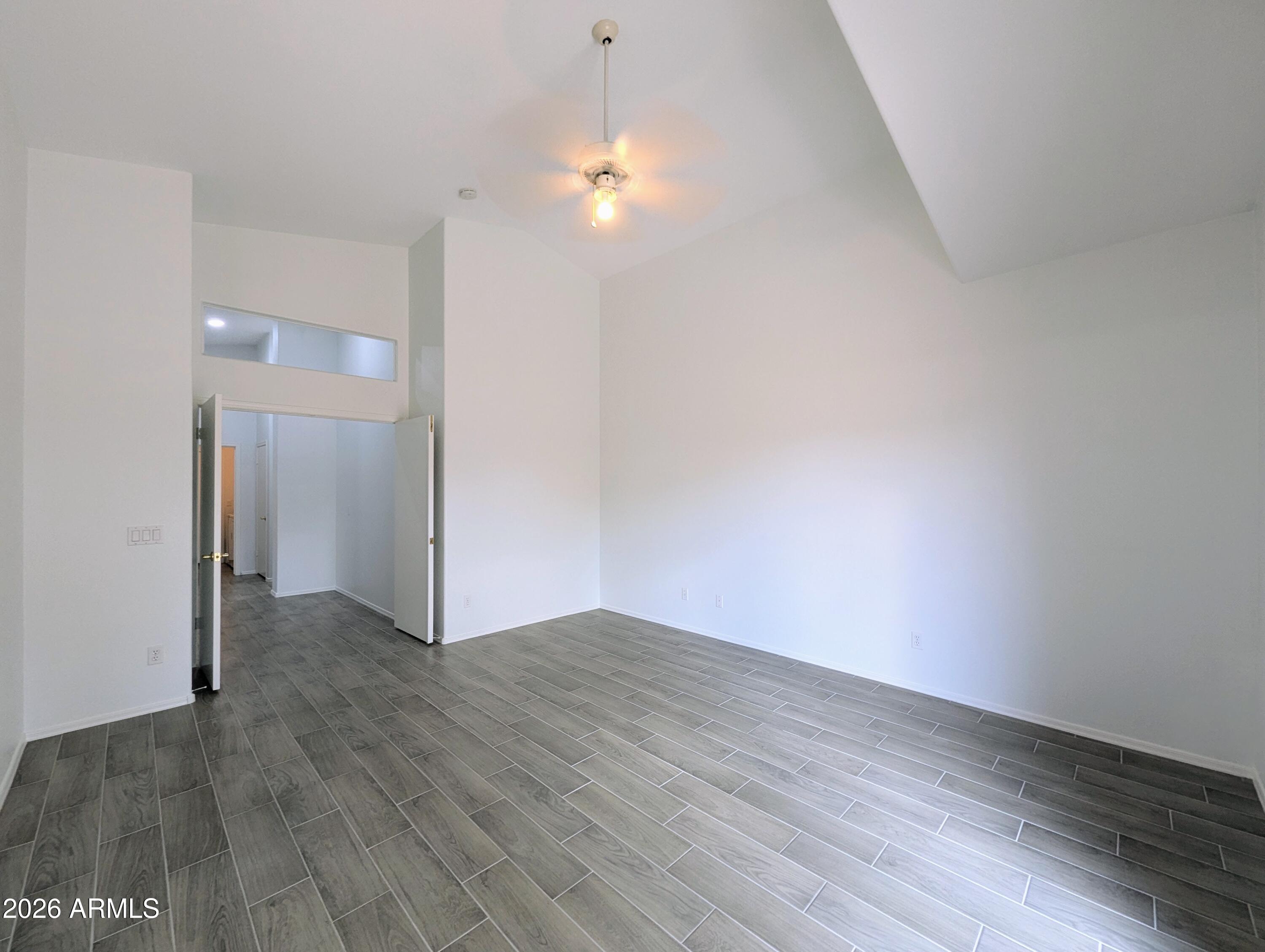5424 West Wagoner Road Glendale, AZ 85308 - Photo 17 of 37 a view of an empty room with wooden floor