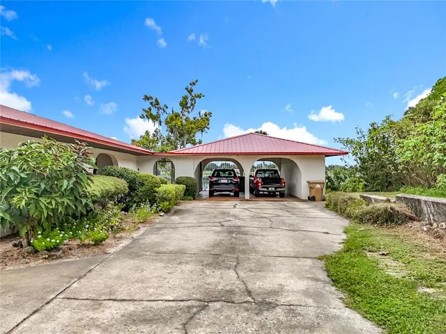 a dining room with furniture garden view and a chandelier