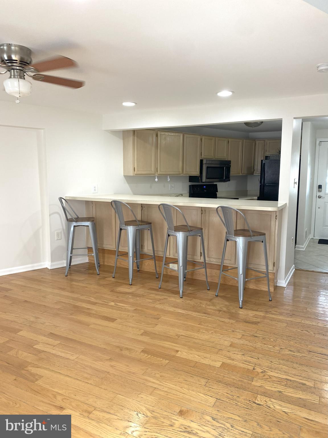 3436 Littleleaf Place Laurel, MD 20724 - Photo 3 of 18 a living room with stainless steel appliances furniture cabinets and a kitchen view