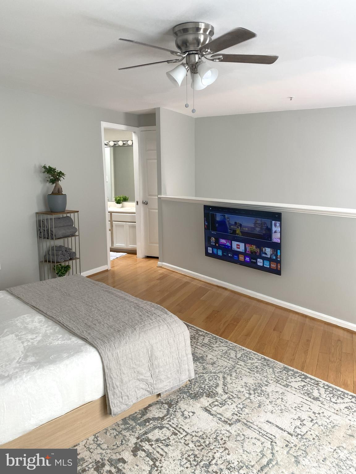 3436 Littleleaf Place Laurel, MD 20724 - Photo 9 of 18 a bedroom with a bed and a dresser with wooden floor