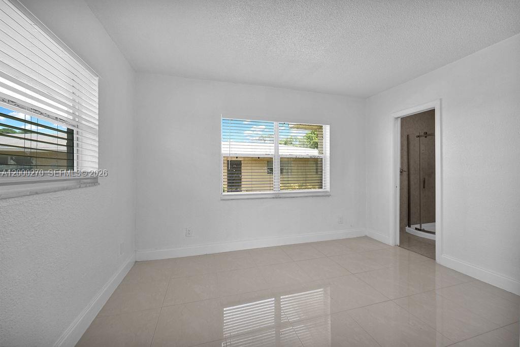 6951 Southwest 7th Street Margate, FL 33068 - Photo 18 of 45 an empty room with windows
