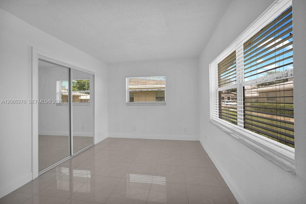 6951 Southwest 7th Street Margate, FL 33068 - Photo 22 of 45 a view of an empty room with windows
