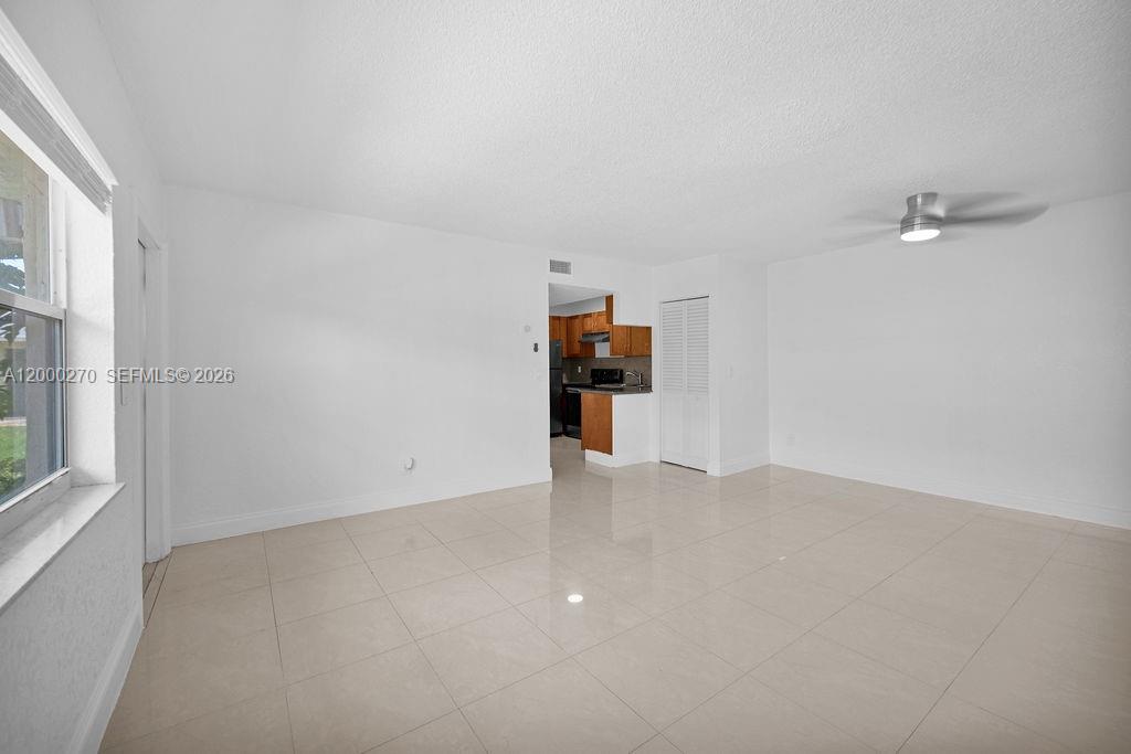 6951 Southwest 7th Street Margate, FL 33068 - Photo 7 of 45 a view of empty room with furniture and window