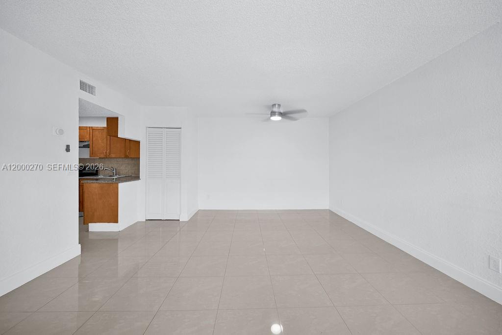 6951 Southwest 7th Street Margate, FL 33068 - Photo 8 of 45 a view of a kitchen with a sink and a refrigerator
