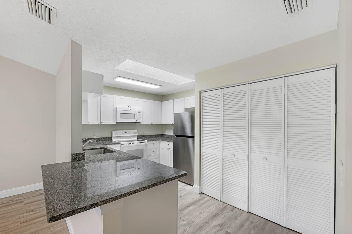 9015 Southeast Hobe Ridge Avenue Hobe Sound, FL 33455 - Photo 12 of 18 Washer/Dryer Closet off Kitchen