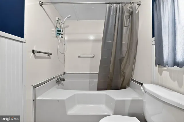 a bathroom with a tub and shower