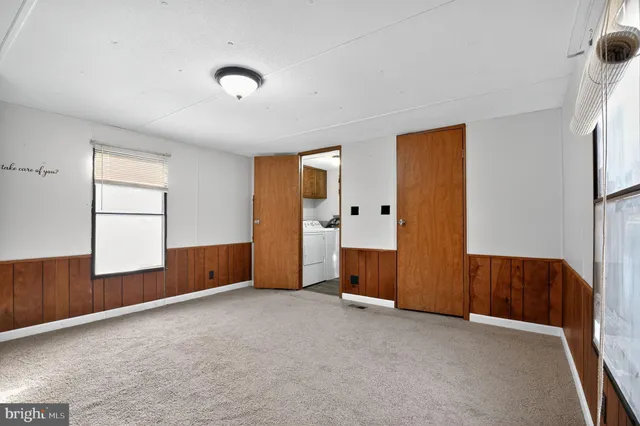 an empty room with windows and closet