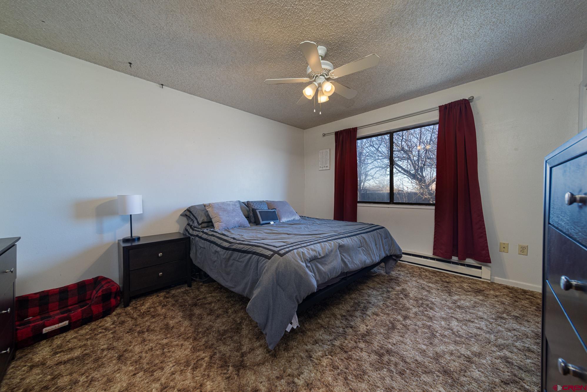 11500 6250th Road Montrose, CO 81401 - Photo 15 of 35 a bedroom with a bed and window