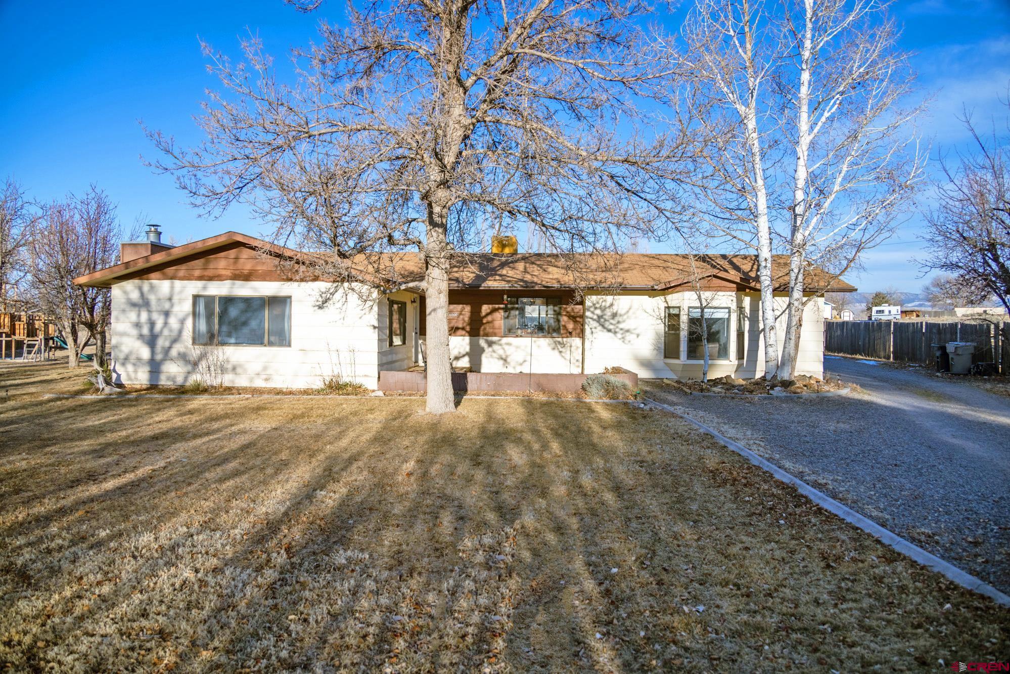 11500 6250th Road Montrose, CO 81401 - Photo 2 of 35 a front view of a house with a yard