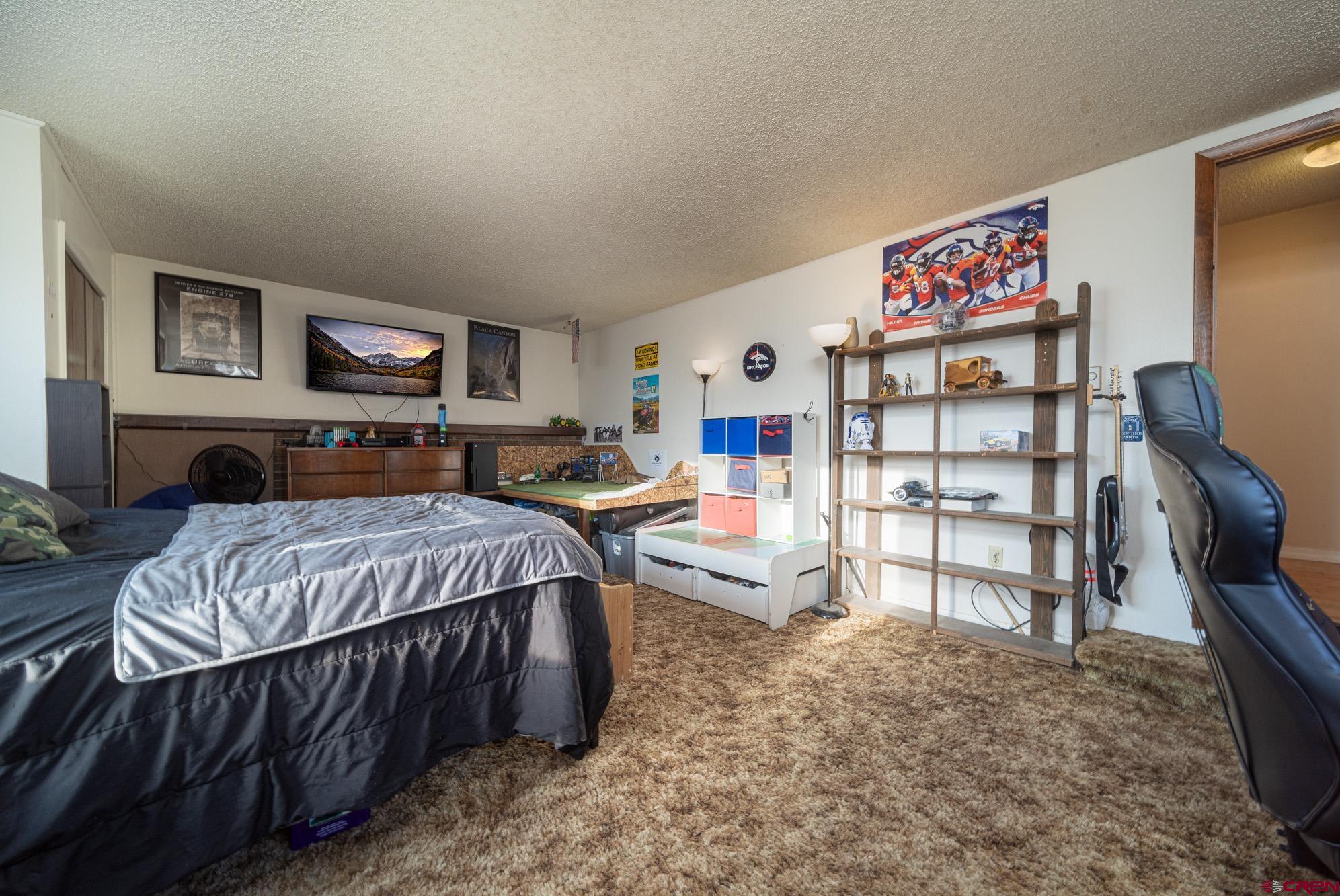 11500 6250th Road Montrose, CO 81401 - Photo 25 of 35 a bedroom with a bed and dresser