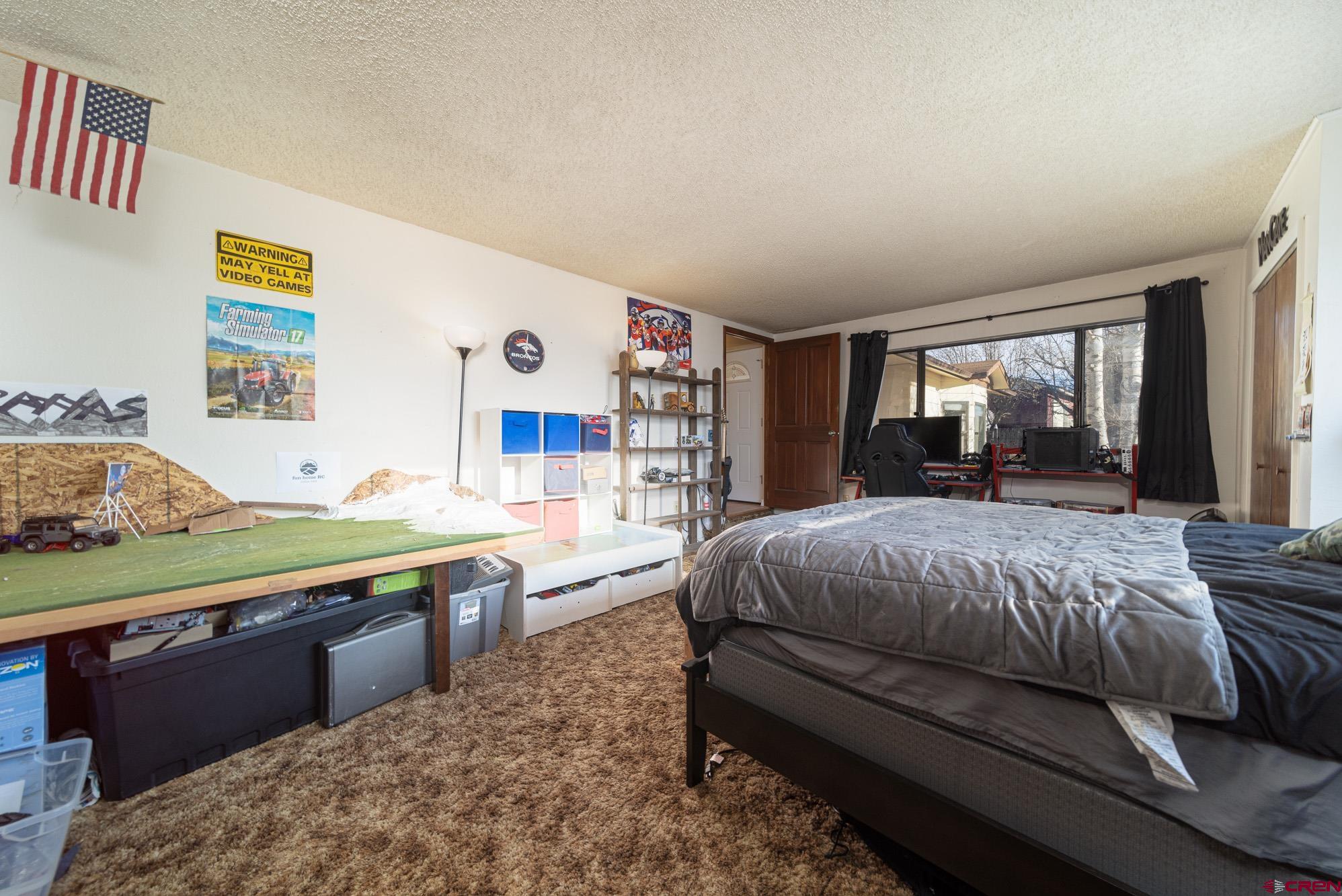 11500 6250th Road Montrose, CO 81401 - Photo 26 of 35 a bedroom with a large bed and a window